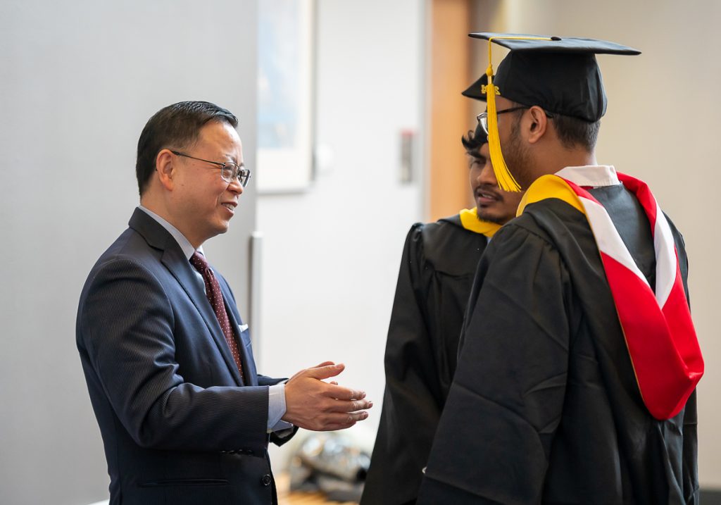 FinMath graduate students with Dr. Pang post commencement