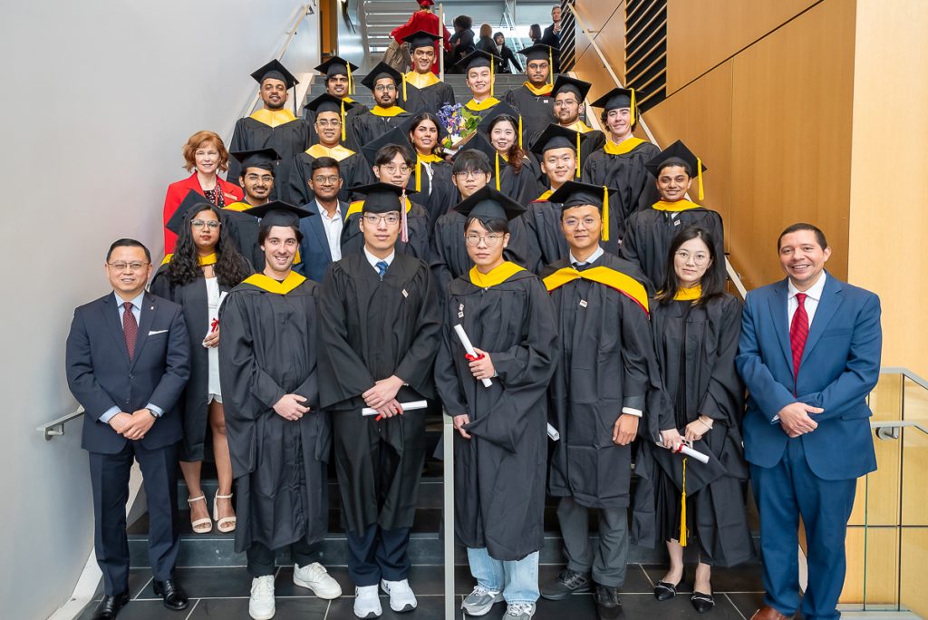 FinMath graduates with program administration posing for a group photo