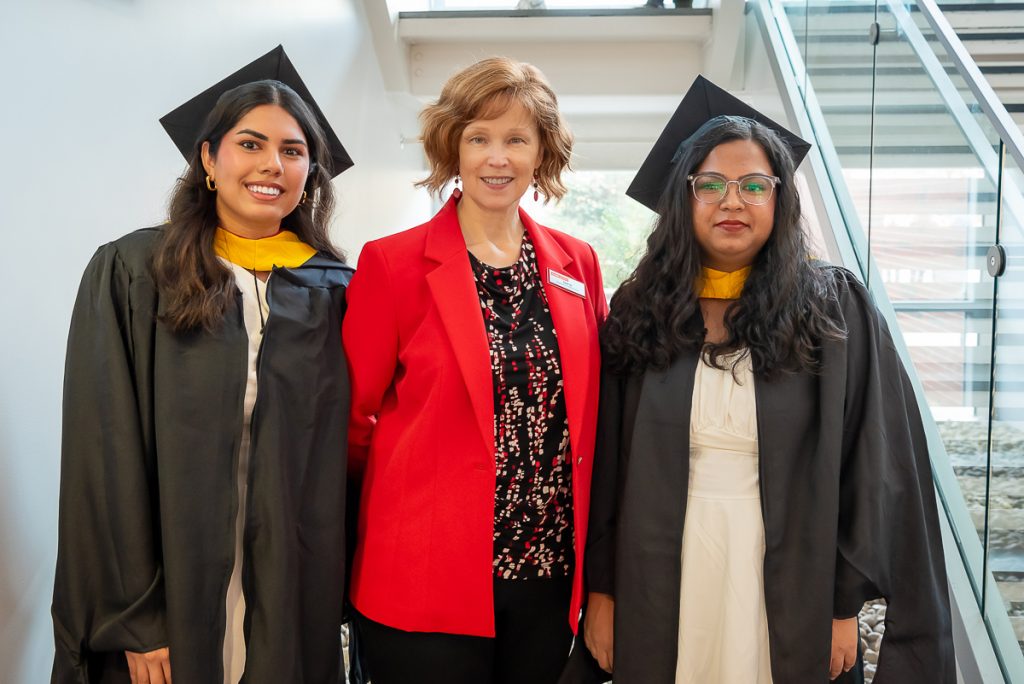 Susan Uy, program specialst for FinMath, with graduating students Prachi and Kavya