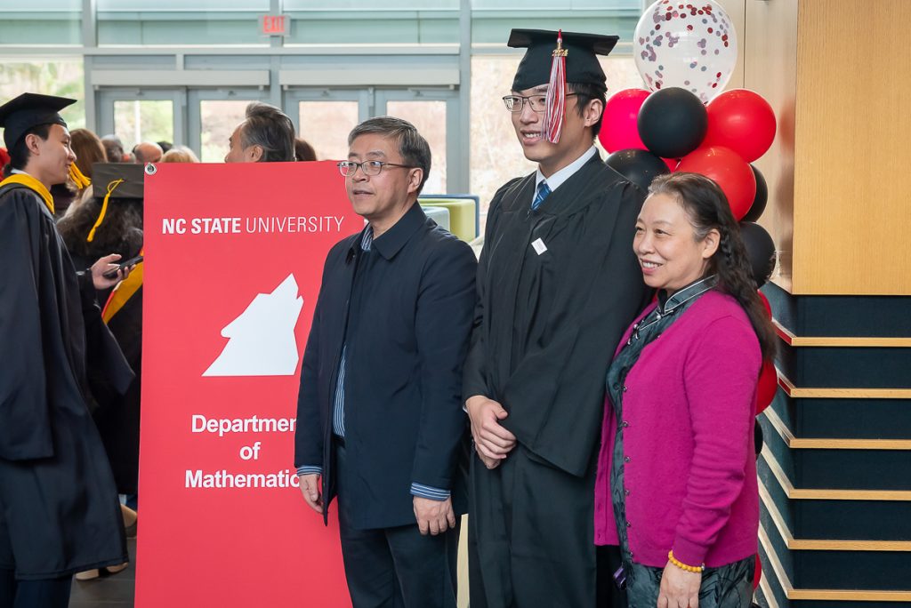 FinMath student and his family posing for photos post commencement